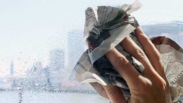 Dùng giấy báo cũ lau sạch bóng kính